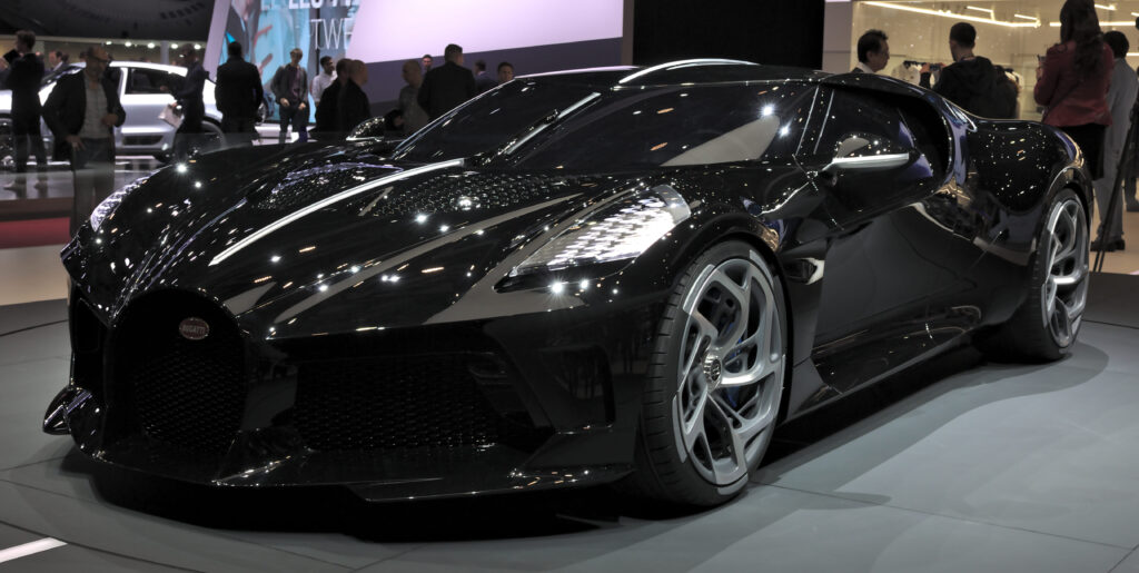 Bugatti La Voiture Noire hypercar, one of the top 10 most expensive cars in the world, with a black color, aerodynamic design, and sharp spoilers.