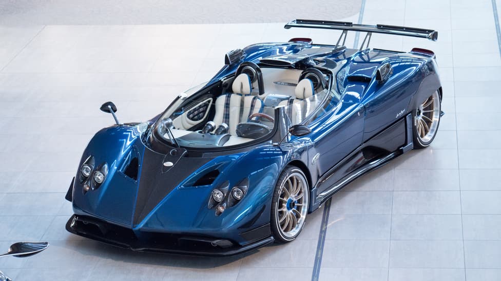 Pagani Zonda HP Barchetta, a limited edition supercar, part of the Top 10 Most Expensive Cars in World 2023 list, featuring carbon fiber body and black leather interior with red accents."